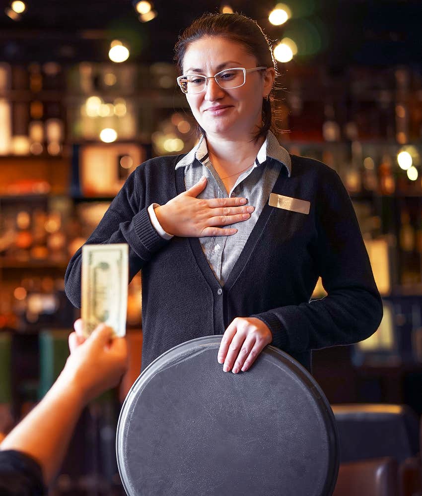 service worker appreciating tip from customer