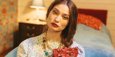 beautiful woman with a conflicted thoughtful expression, illustrating the hidden complications and quiet costs that often come with being seen as ‘pretty’