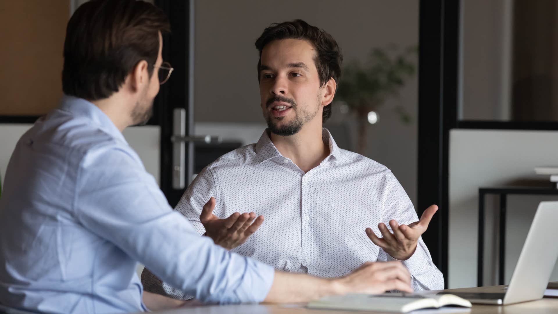 man in white shirt doesn't overshare in personal setting as he sets boundary with coworker