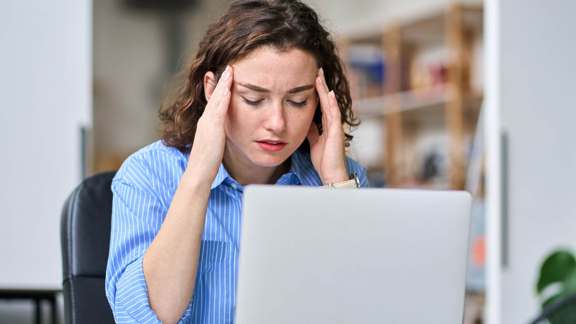 stressed woman at work struggling to notice and acknowledge her emotions