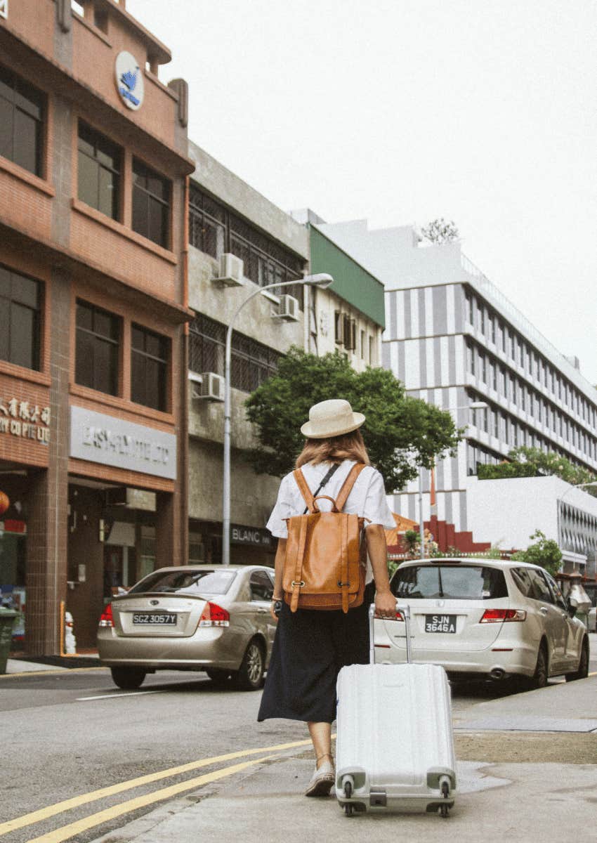 woman walking away with her suitcase