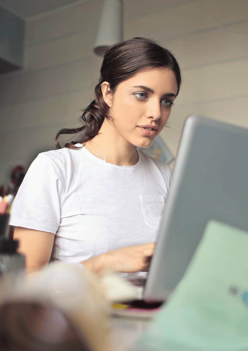 young woman focused on computer screen